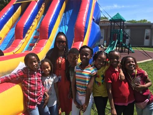 Students and teachers in front of an inflatable